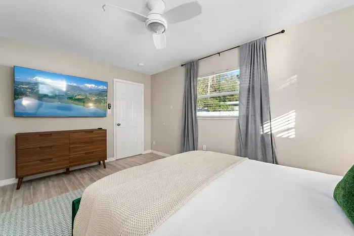Bedroom with Queen bed, TV, and ensuite bathroom.