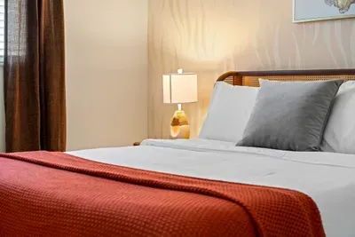 Bedroom with Queen bed and ceiling fan.