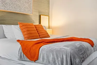 Main bedroom with a king bed, ceiling fan, and TV