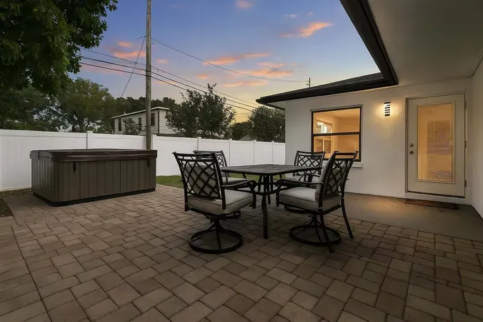 Outdoor furniture next to the hot tub to enjoy evenings with your loved ones!