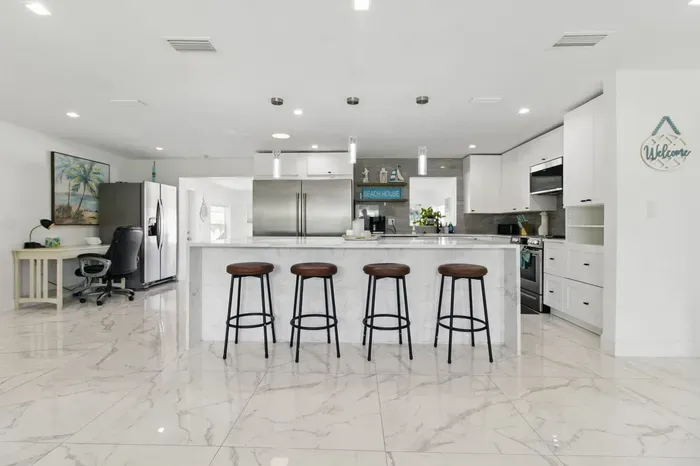Pull up a seat at the stylish kitchen counter, featuring four comfortable high chairs—perfect for casual meals, morning coffee, or chatting with the cook.