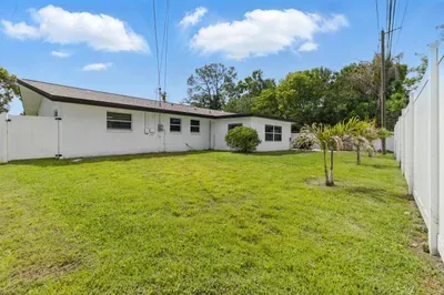This photo captures the charming side of the house, showcasing its clean lines and inviting atmosphere. The well-maintained exterior adds to the overall appeal of the property, offering a peaceful and serene setting during your stay.
