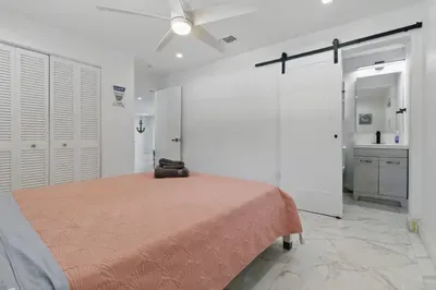 Enjoy restful nights in this cozy bedroom featuring a comfortable double-sized bed and convenient access to a private bathroom. Perfect for relaxation and privacy, this setup offers everything you need for a comfortable and seamless stay.