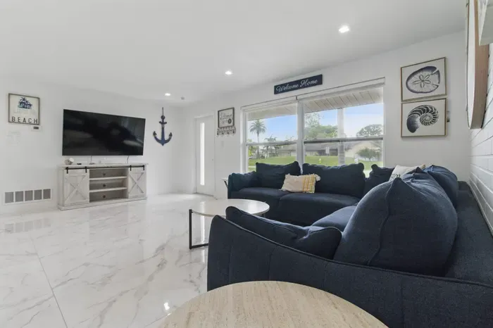 Kick back and relax in this cozy living room, complete with a comfy sofa and a flat-screen smart TV—perfect for movie nights, streaming your favorite shows, or unwinding after a day out. The space is designed for comfort and connection.