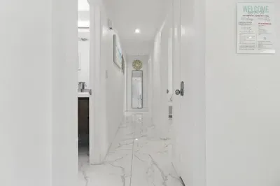 This hallway offers plenty of space for easy movement, making it comfortable to walk through as you navigate between rooms. Its open layout ensures you can move freely without feeling cramped, adding to the overall comfort of the home.