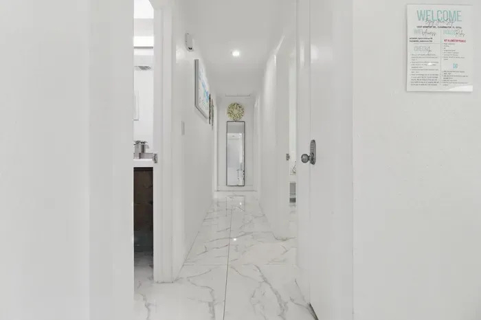 This hallway offers plenty of space for easy movement, making it comfortable to walk through as you navigate between rooms. Its open layout ensures you can move freely without feeling cramped, adding to the overall comfort of the home.