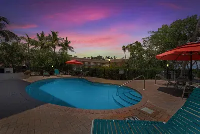 Unwind by the sparkling pool under a stunning sunset sky. Surrounded by palm trees and cozy lounge chairs, this tropical retreat invites you to relax, swim, and soak in the peaceful evening glow in true vacation style.