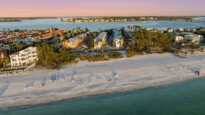 Breathtaking aerial view of pristine white sands and calm turquoise waters. Perfectly located for sunset strolls, beach lounging, and soaking in the beauty of this peaceful Gulf Coast paradise.