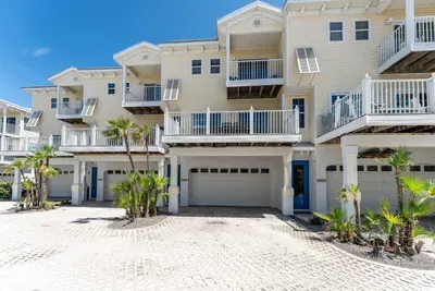 Bright and inviting coastal townhomes just steps from the beach! Enjoy private balconies, tropical landscaping, and modern comfort in this peaceful seaside community.