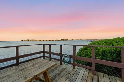 Tranquil waterfront deck with sunset views over the bay. Enjoy peaceful evenings, gentle breezes, and stunning skies—an ideal spot to relax and soak in the beauty of coastal living.