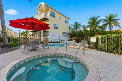 Relax and unwind in the inviting hot tub beside the pool, surrounded by palm trees and sun loungers. The perfect tropical spot to soak, sip, and enjoy the warm coastal breeze.
