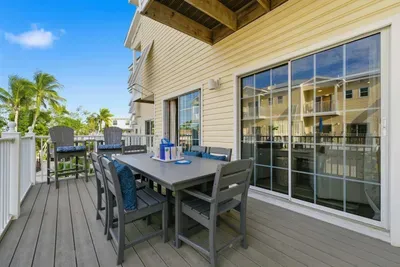 Spacious private balcony with outdoor dining and lounge seating. Enjoy sunny mornings, tropical breezes, and peaceful evenings in this perfect coastal retreat.
