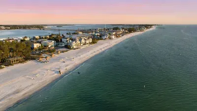 Endless shoreline views meet calm turquoise waves and pastel sunsets. This stunning beach setting offers peace, beauty, and the perfect backdrop for your coastal escape.