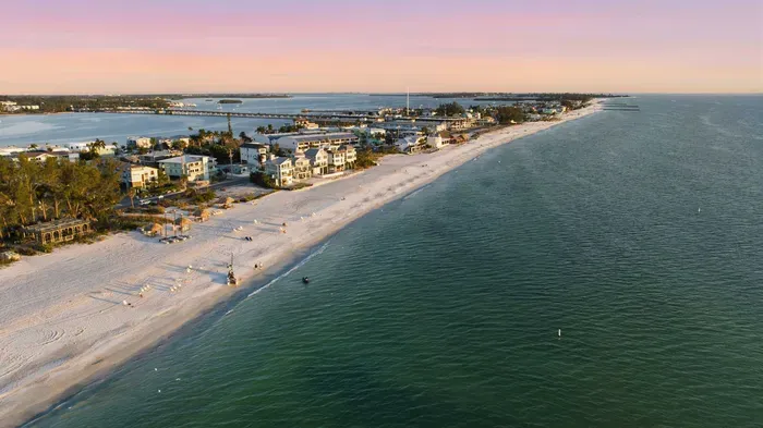 Endless shoreline views meet calm turquoise waves and pastel sunsets. This stunning beach setting offers peace, beauty, and the perfect backdrop for your coastal escape.