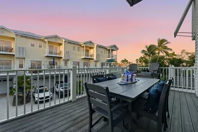 Relax on the private balcony with outdoor dining and sunset views. Perfect for morning coffee or evening cocktails surrounded by palm trees and coastal charm.