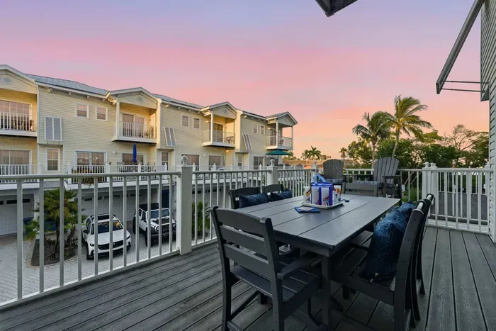 Relax on the private balcony with outdoor dining and sunset views. Perfect for morning coffee or evening cocktails surrounded by palm trees and coastal charm.