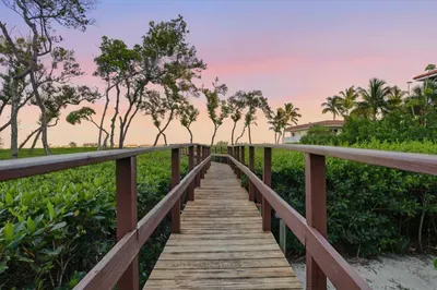 Stroll this scenic boardwalk surrounded by lush greenery leading to the beach. Perfect for sunset walks, morning coffee views, or simply soaking in the serene coastal beauty.