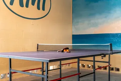 Enjoy a friendly match in this fun game area featuring a ping pong table and beachy vibes. Perfect for family tournaments or casual play after a day in the sun—where relaxation meets a little friendly competition!
