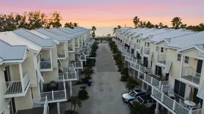 Charming coastal community at sunset, with pastel skies and beachside villas leading to the ocean. Enjoy peaceful evenings, sea breezes, and the perfect setting for a relaxing getaway.