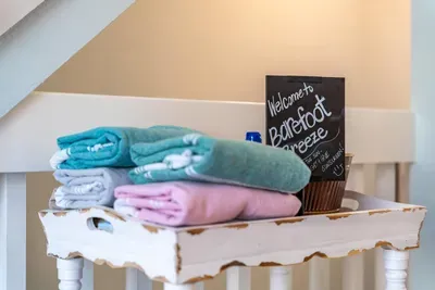 A warm coastal welcome awaits with fresh towels and beachy touches. Thoughtful details like this add charm and comfort, setting the tone for a relaxing stay.