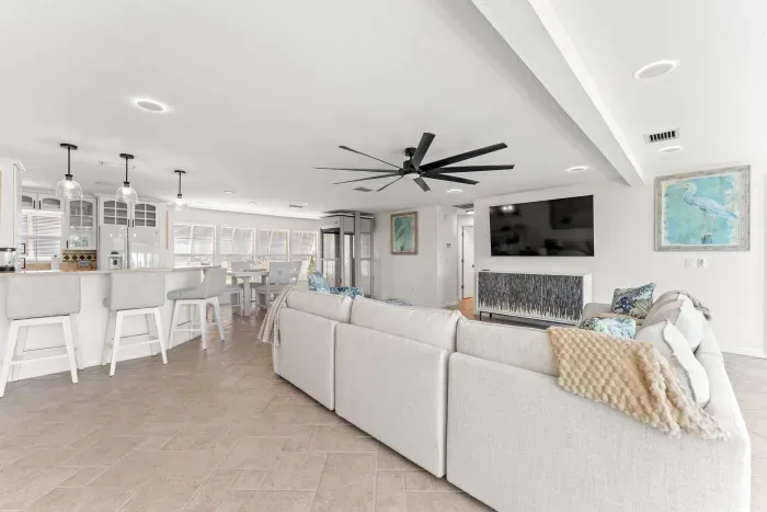 Modern coastal getaway with an open-concept design. Enjoy spacious living, cozy seating, and a bright kitchen perfect for gathering with family and friends after a fun day on the water or at the beach!