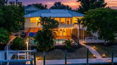 Stunning waterfront escape at sunset 🌅🌴 Enjoy tropical vibes, glowing evening views, and relaxing poolside moments just steps from the water. The perfect getaway for making unforgettable memories with family and friends!