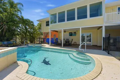Resort-style pool and spa oasis. Relax in the sparkling private pool, soak in the spa, and enjoy sunny Florida days in this beautiful tropical waterfront retreat perfect for unforgettable vacations!