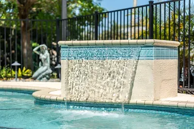Relax by the soothing pool waterfall. Enjoy peaceful tropical vibes, sparkling waters, and the perfect setting for sunny afternoons and unforgettable Florida vacation memories with family and friends!