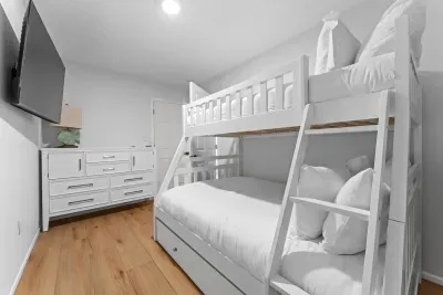 Fun and cozy bunk room. Perfect for kids, friends, or extra guests, this comfortable space features built-in bunk beds, a TV, and everything needed for relaxing after a fun day at the beach or pool!