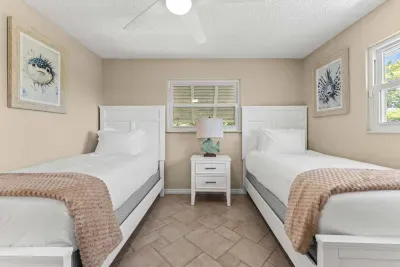 This cozy twin bedroom offers a bright, relaxing space with comfortable beds and coastal charm — ideal for unwinding after a fun day at the beach or pool!