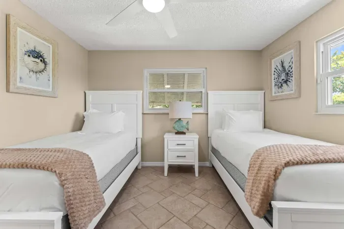 This cozy twin bedroom offers a bright, relaxing space with comfortable beds and coastal charm — ideal for unwinding after a fun day at the beach or pool!