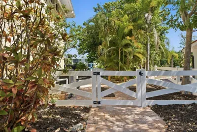 Private tropical entrance surrounded by lush palms. Enjoy peaceful island vibes, beautiful landscaping, and a relaxing waterfront atmosphere from the moment you arrive at this unforgettable Florida getaway!
