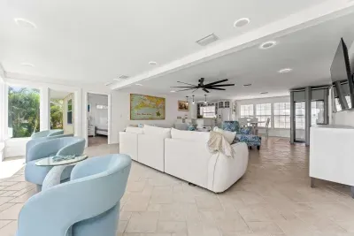 Open-concept coastal living. Enjoy a bright, spacious layout with comfortable seating, tropical views, and plenty of room to gather with family and friends. Perfect for relaxing, entertaining, and making lasting vacation memories!