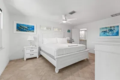 Spacious and serene coastal bedroom. Unwind in comfort with a cozy king bed, calming décor, and a bright relaxing atmosphere — the perfect place to recharge after a fun day exploring Anna Maria Island!