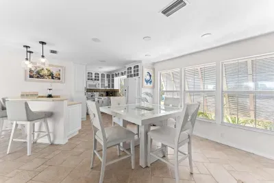 Bright and airy dining space. Enjoy meals together in this beautiful open-concept area filled with natural light, coastal charm, and the perfect atmosphere for unforgettable family dinners and vacation moments!