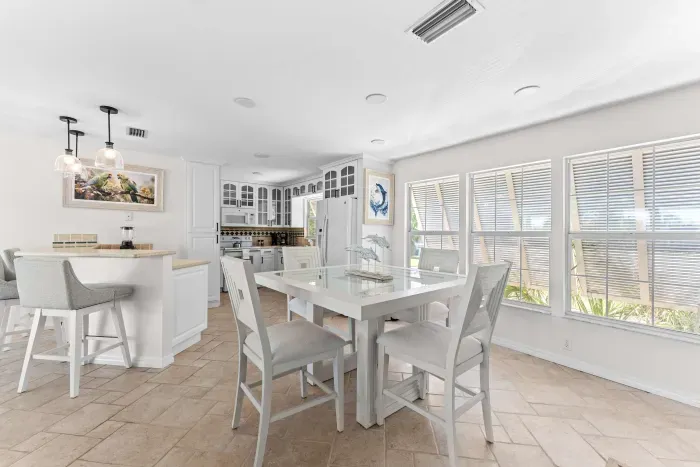 Bright and airy dining space. Enjoy meals together in this beautiful open-concept area filled with natural light, coastal charm, and the perfect atmosphere for unforgettable family dinners and vacation moments!