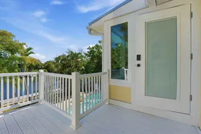 Private balcony entrance with tropical views. Enjoy peaceful outdoor space overlooking the pool area — the perfect spot to sip your morning coffee or unwind after a fun day exploring Anna Maria Island!