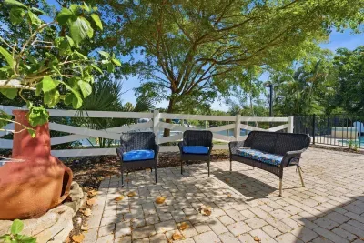 Relax in this peaceful outdoor lounge area. Surrounded by tropical landscaping and shaded seating, it’s the perfect spot for morning coffee, evening conversations, or unwinding after a fun beach day!