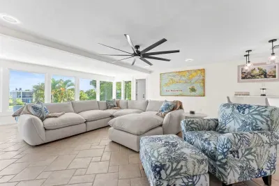 Spacious and cozy living area. Relax in comfort with plenty of seating, natural light, and beautiful waterfront views. The perfect gathering space for movie nights, family time, or unwinding after a fun beach day!