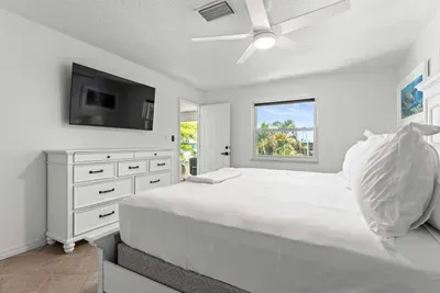 Relax and recharge in this bright, peaceful space featuring a comfy bed, soft natural light, and a TV for winding down after a fun day at the beach or on the water!