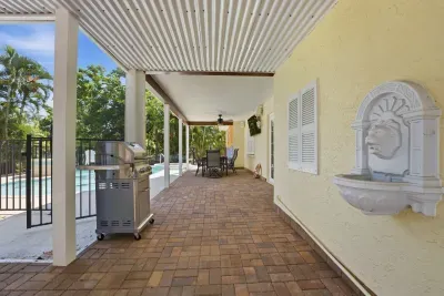 Enjoy grilling, outdoor dining, and relaxing poolside in this shaded tropical space — perfect for gathering with family and friends during your Florida getaway!
