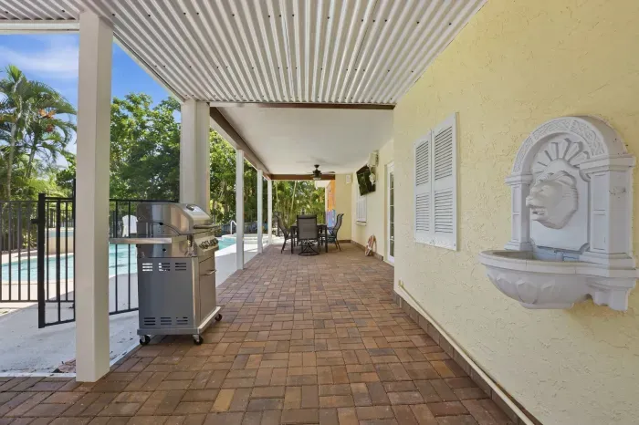 Enjoy grilling, outdoor dining, and relaxing poolside in this shaded tropical space — perfect for gathering with family and friends during your Florida getaway!