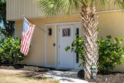 Welcoming private entrance with tropical charm. Surrounded by lush landscaping and island vibes, this cozy entryway sets the tone for a relaxing and unforgettable Florida waterfront getaway!