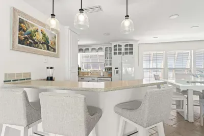 Stylish coastal kitchen and dining area. Gather around the spacious island, enjoy home-cooked meals, and relax in this bright open-concept space designed for comfort, connection, and unforgettable vacation memories!