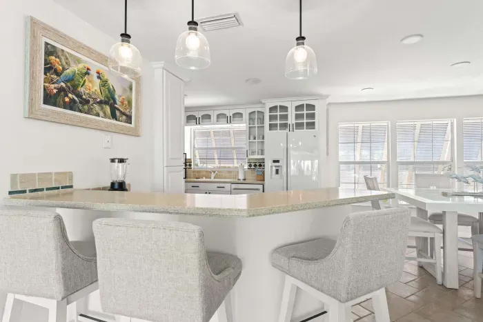Stylish coastal kitchen and dining area. Gather around the spacious island, enjoy home-cooked meals, and relax in this bright open-concept space designed for comfort, connection, and unforgettable vacation memories!