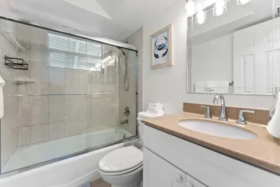 Enjoy a clean, comfortable space with a full tub and shower — perfect for refreshing after a beach day.