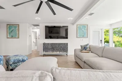 Bright and inviting coastal retreat. Gather with family and friends in this spacious living area featuring cozy seating, tropical-inspired décor, and the perfect space to relax after a fun day by the water!