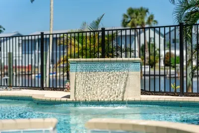 Relax beside the sparkling pool and calming waterfall while soaking in the tropical Florida sunshine and laid-back island vibes during your unforgettable getaway!