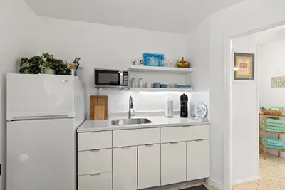 Kitchen area leading to bathroom and bedroom.
