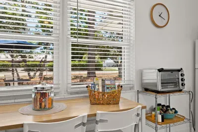 Dinette table for two, welcome brochures, treats for guests, air fryer, and spices.